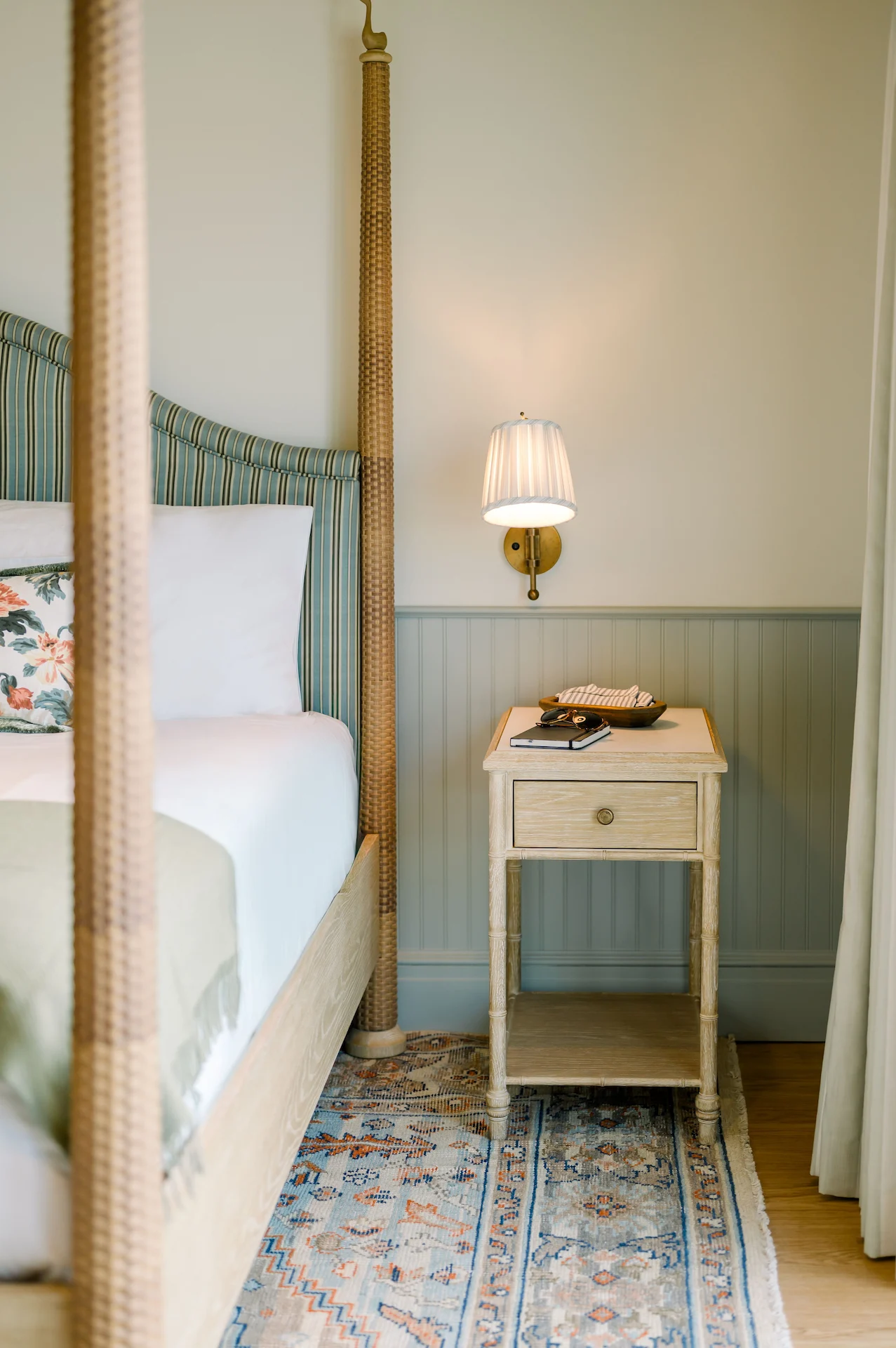 Nightstand with a cozy light next to the king-size bed in the suite at the Sanderling Hotel.