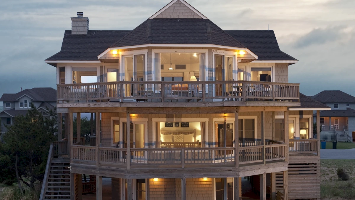 Front aerial view of Caffey House 6 Bedroom Residence at sunset.