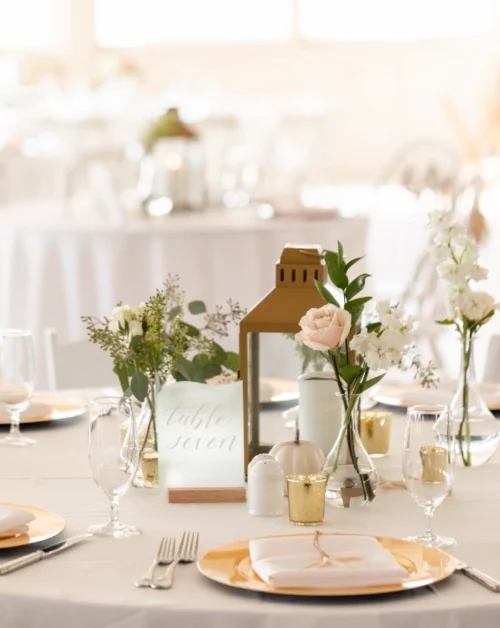 Elegant table number 7, adorned with a charming candle centerpiece and delicate floral motifs.