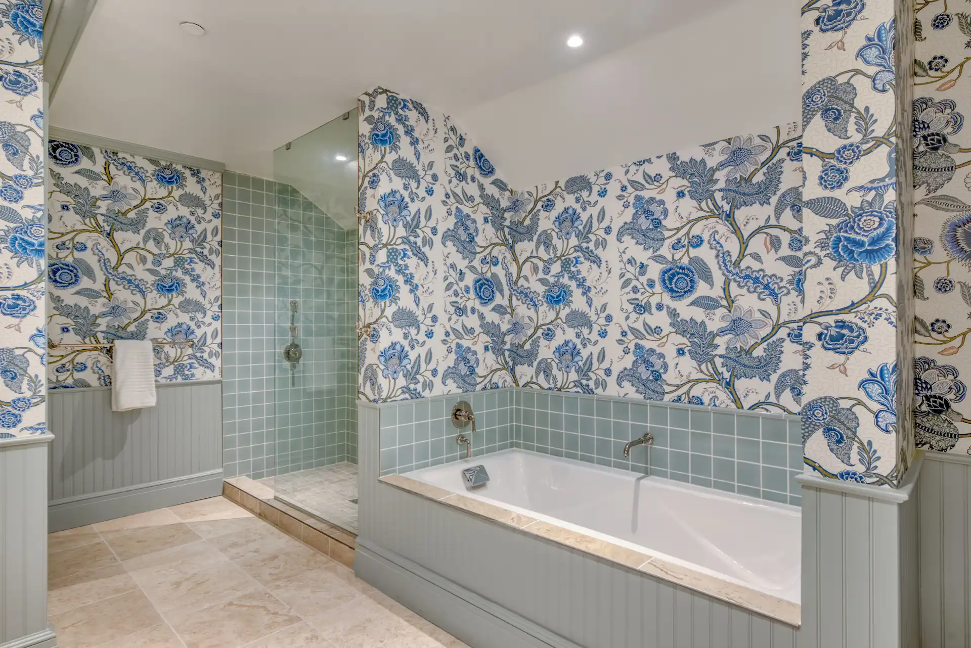 Bathroom with floral-patterned walls, featuring both a bathtub and a shower for ultimate relaxation.