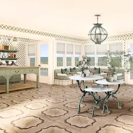 Room with tables and a small bar in the back, featuring large windows with sea views.