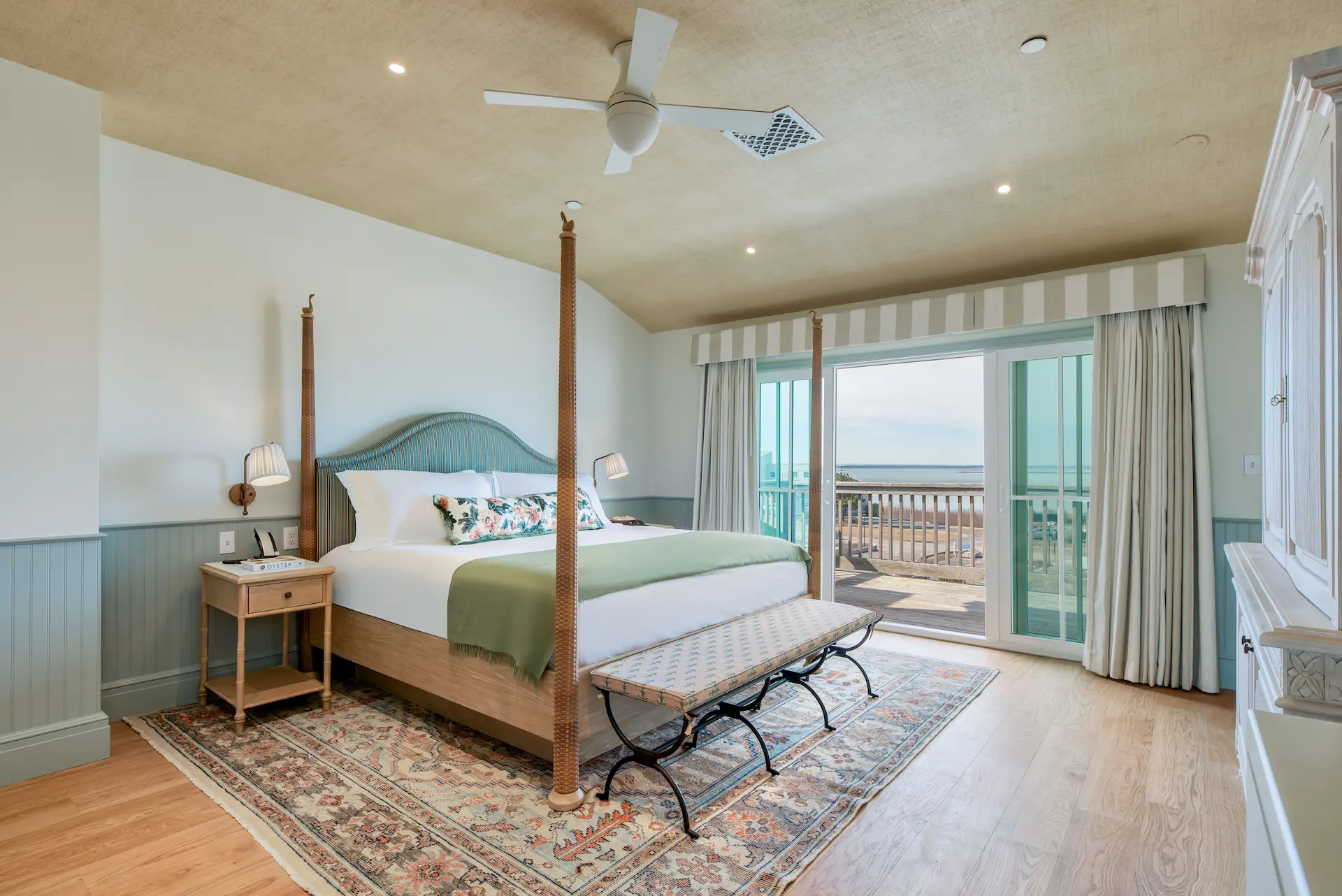 Spacious room with a king-size bed and a balcony offering stunning ocean views.